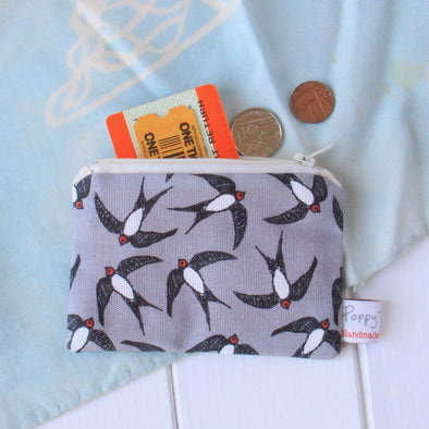 swallows small coin purse
